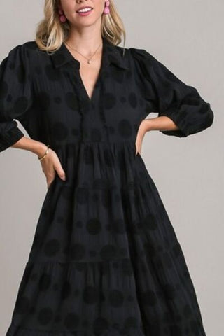 closeup view of long sleeve black dotted jacquard midi dress with v neck
