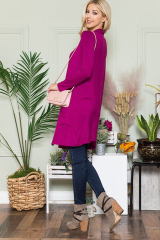 side view of magenta cardigan made from rayon, large pockets