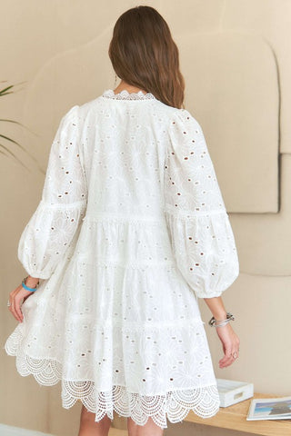 Rear view of white tiered babydoll dress with lace and eyelets