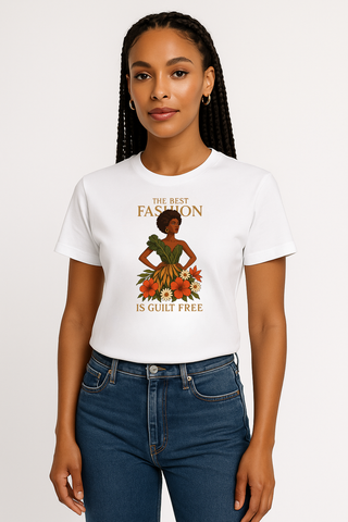Woman wearing a white t-shirt and jeans; the shirt has a graphical image of a woman in plant based fashion with an expression that says The Best Fashion is Guilt Free. 
