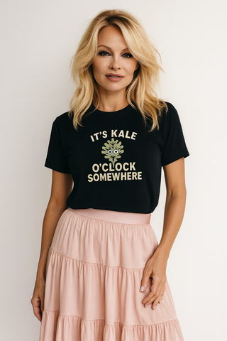 Woman wearing a funny vegan black t-shirt that says It's Kale O'Clock Somewhere