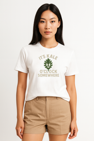 Woman wearing a white t-shirt with 'It's Kale O'Clock Somewhere' text and a green leaf graphic on a white background