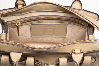 Interior view of Lavāda vegan leather handbag in tan showing micro suede lining with zippered interior back pocket. 