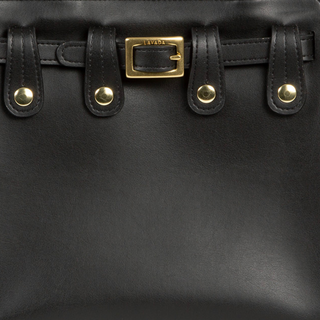 Close up view of Lavāda vegan leather black handbag featuring belt and buckle.