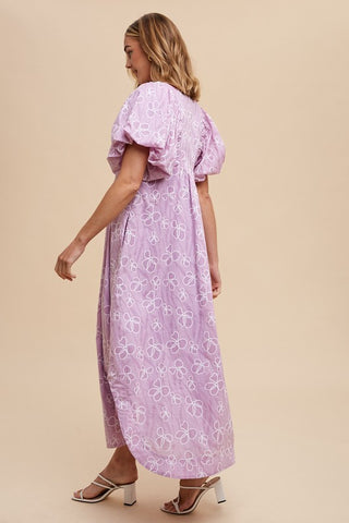 Pink and purple floral smocked puff sleeve midi dress with modest side slit, three quarter view