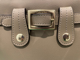 Close up view of Lavāda tan cactus vegan leather handbag belt and buckle 