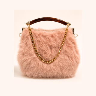 A blush pink faux fur evening bag with a curved brown handle, a 24K gold chain strap, and gold hardware, shown against a solid pale pink background.