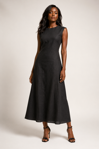 Woman wearing a black sleeveless 100% linen A-line long dress on a white background