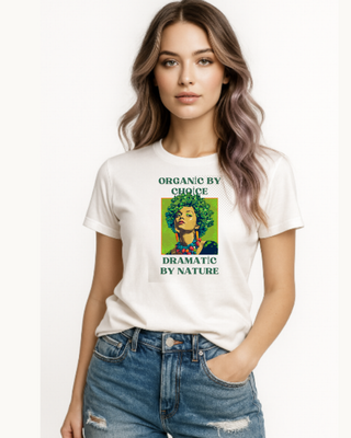 Woman wearing a white t-shirt with a graphic design of a woman with kale hair. The caption is 'organic by choice, dramatic by nature'
