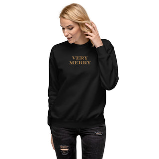 model wearing gold embroidered Very Merry sweatshirt in black