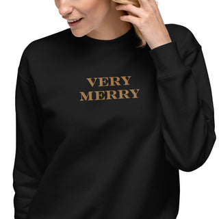 closeup of model wearing gold embroidered Very Merry sweatshirt in black