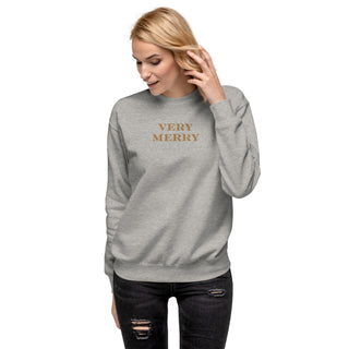 model wearing gold embroidered Very Merry sweatshirt in carbon gray