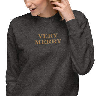 closeup of model wearing gold embroidered Very Merry sweatshirt in charcoal heather