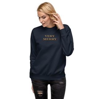 model wearing gold embroidered Very Merry sweatshirt in navy blue