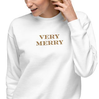 closeup of model wearing gold embroidered Very Merry sweatshirt in white